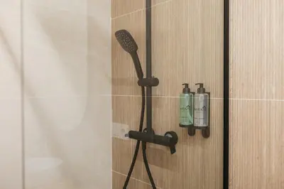 a shower with a blow dryer and bottles on a wall at Elegant Loft in Valencia in Valencia