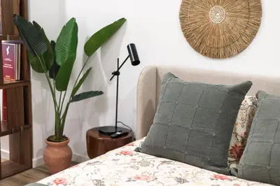 a room with a couch with a pillow and a plant at Moderno loft reformado, Smart TV, AC, Beach, 3Pax in Valencia