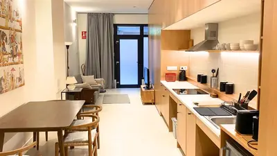 a bedroom with a bed and a table on the wall at El Apartamento in Valencia