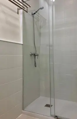 a shower with a glass door in a bathroom at El Apartamento in Valencia