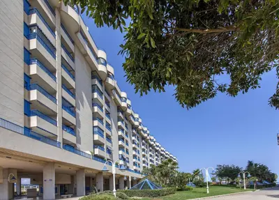a large building with a blue sky in the background at ApartUP Patacona Iconic I in Valencia