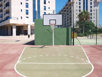 a basketball court with a hoop in a city at ApartUP Patacona Iconic I in Valencia