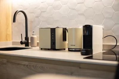 a kitchen counter with two coffeemakers on it at Apartamento 4 Pax Vistas Torres de Serrano in Valencia