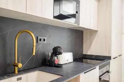 a kitchen with a counter top with a sink at Valencia Central Flats - Exclusiva, junto al Roig Arena in Valencia