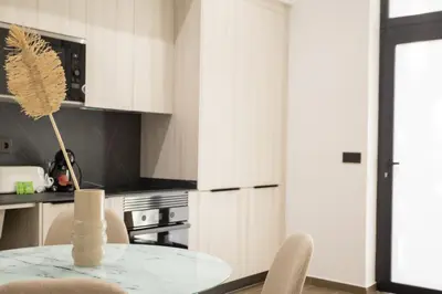 a kitchen with a table with a vase on it at Valencia Central Flats-Elegante, junto al Roig Arena in Valencia