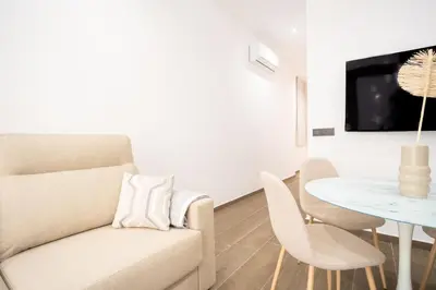 a living room with a couch and a table at Valencia Central Flats-Elegante, junto al Roig Arena in Valencia