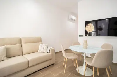 a living room with a couch and a table at Valencia Central Flats-Elegante, junto al Roig Arena in Valencia