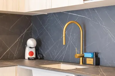 a kitchen counter with a sink with a faucet at Valencia Central Flats-Moderno, junto al Roig Arena in Valencia