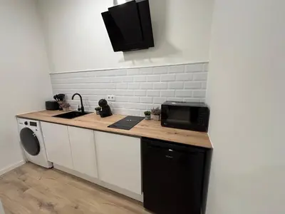 a kitchen with a counter and a sink and a microwave at Valencia City Scapes in Valencia