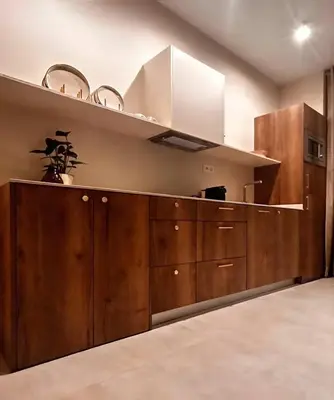 a kitchen with wooden cabinets and a hood at Pivote Flats-Playa A in Valencia