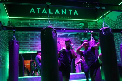 a group of men standing in front of a nightclub at Fitness & Spa, Suite Atalanta Valencia in Valencia