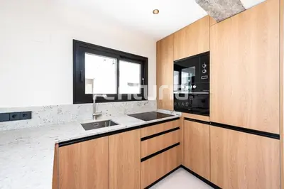 a kitchen with wooden cabinets and a sink and a window at Carme Sky in Valencia