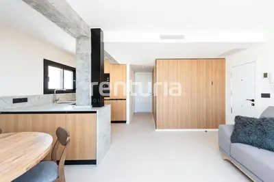a kitchen and living room with a table and a couch at Carme Sky in Valencia