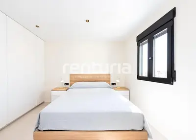 a white bedroom with a bed and a window at Carme Sky in Valencia