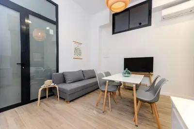 a living room with a couch and a table at Parque de Cabecera & Bioparc Apartment in Valencia