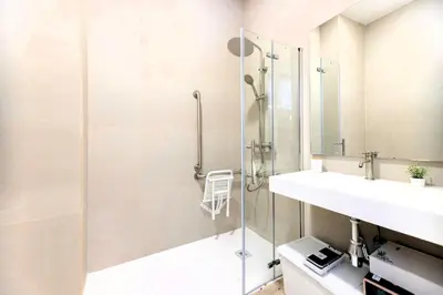 a bathroom with a glass shower and a sink at Parque de Cabecera & Bioparc Apartment in Valencia