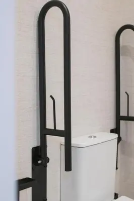 a toilet in a bathroom with black metal bars at District Key - Valencia, Fuencaliente D in Valencia