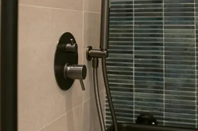a doorhandle to a shower in a bathroom with a window at District Key - Valencia, Fuencaliente D in Valencia