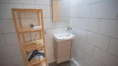 a small bathroom with a sink and a shelf at LOWCOST Beach & CityCenter in Valencia