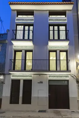 a white building with a balcony on top of it at Ca La Leni Beach 0 in Valencia