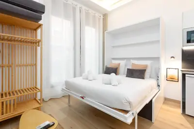 a white bedroom with a large white bed in a room at Ca La Leni Beach 0 in Valencia