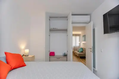 a bedroom with a bed with orange pillows on it at Malva Playa in Valencia