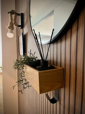 a wooden planter on a wall with a plant at Mar in Valencia