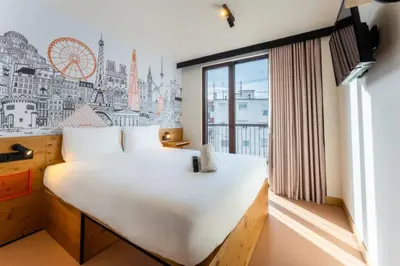 a bedroom with a large white bed and a window at easyHotel Valencia Ciutat Vella in Valencia