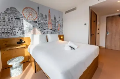 a bedroom with a bed and a desk and a window at easyHotel Valencia Ciutat Vella in Valencia