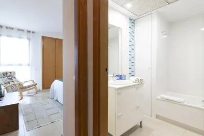 a bathroom with a sink and a bath tub at Dorm4You Patacona in Valencia