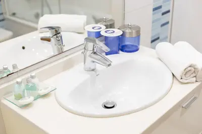 a bathroom sink with toiletries and a mirror at Dorm4You Patacona in Valencia