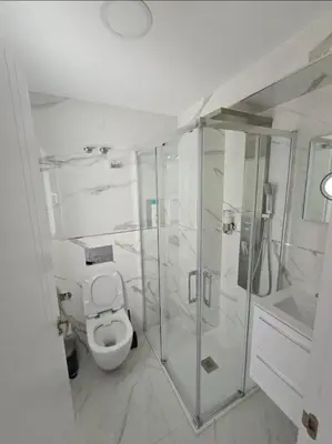 a white bathroom with a toilet and a shower at Paradise Home in Valencia