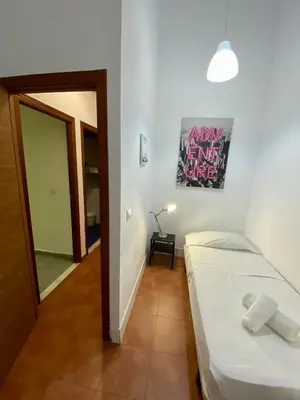a small room with a bed and a hallway at Alojamiento Familiar cerca de la Playa Valencia in Valencia