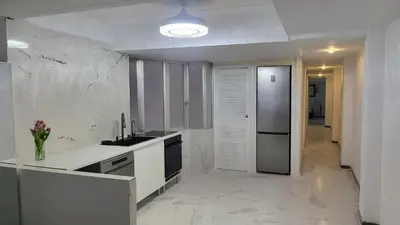 a white kitchen with a sink and a refrigerator at Medusa Felix in Cullera