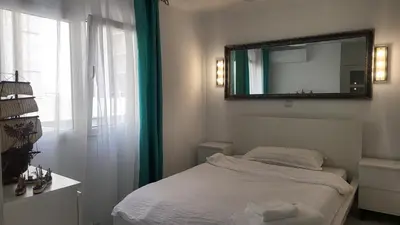 a bedroom with a bed with a mirror and a window at Medusa Felix in Cullera