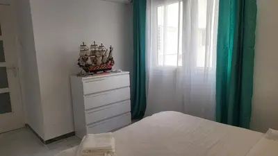 a bedroom with a bed and a dresser with a window at Medusa Felix in Cullera