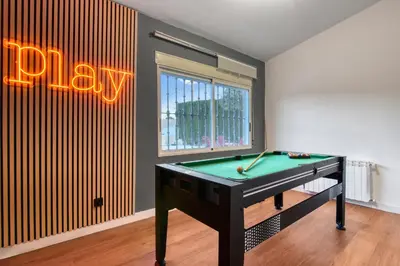 a pool table in a room with a play sign at Private Garden Villa near Valencia with Cinema and Gym in La Eliana