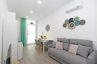 a living room with a couch and a table at GuestReady - Llovera apartments in Valencia