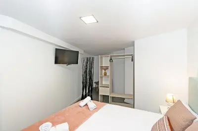 a bedroom with a bed and a tv on the wall at GuestReady - Llovera apartments in Valencia