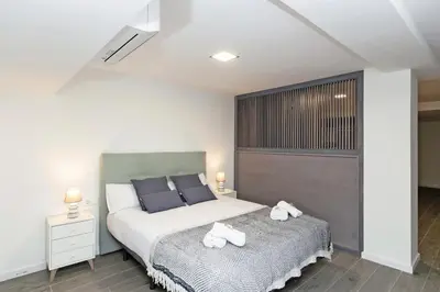 a bedroom with a bed with two towels on it at GuestReady - Llovera apartments in Valencia