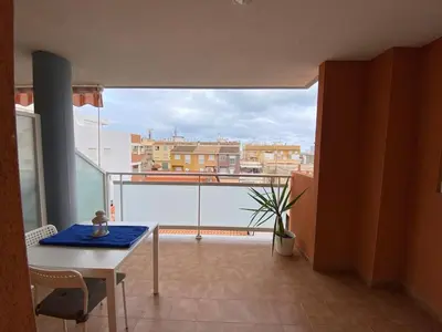 a room with a table and a view of a city at Apartamento playa de chilches in Chilches