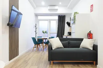 a living room with a couch and a table at Total Valencia Sorolla in Valencia