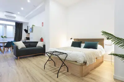 a bedroom with a bed and a couch at Total Valencia Sorolla in Valencia