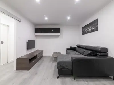 a living room with a couch and a tv at Winahost Paterna Palisses in Paterna
