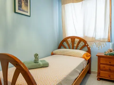 a small childs bedroom with a bed and a window at Apartamento Pinzón in Moncófar