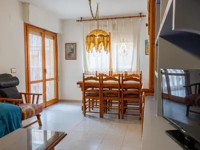 a living room with a dining room table and chairs at Apartamento Pinzón in Moncófar