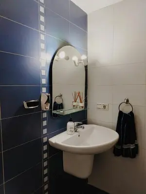 a bedroom with a bed and a wooden cabinet at Playa sol y arena in Valencia