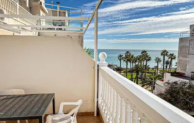 a balcony with a table and a view of the ocean at 2 Bedroom Awesome Apartment In Moncofa in Moncófar