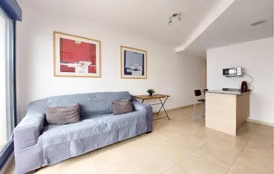 a living room with a couch and a table at 2 Bedroom Awesome Apartment In Moncofa in Moncófar