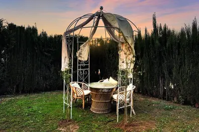 a gazebo with a table and chairs under it at Villa near Valencia 17PAX, Pool, Cinema, BBQ, KidsRoom in Manises